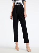 a woman in black cigarette pants